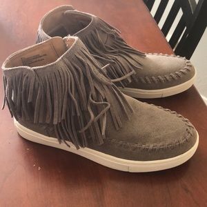Fringe high top tennis shoes.